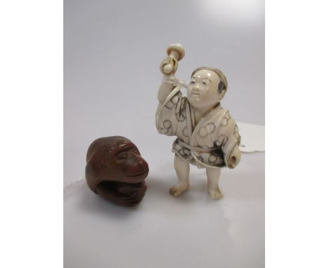 A wood netsuke and a marine ivory okimono  