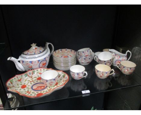 An early 19th century part teaset with naieve 'lion' motif decoration within panels, with 10 cups and saucers, teapot, jug, b