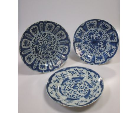 A Kangxi blue and white plate the rim with lappet panels of flower stems on a cracked ice ground and two others similar (3)  