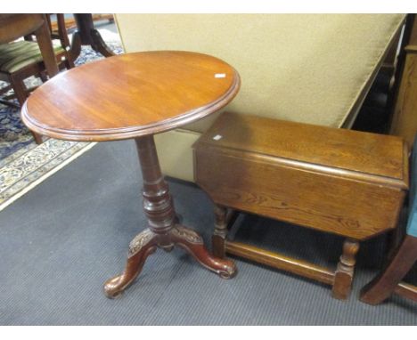 A circular mahogany tripod table together with a small oak drop leaf table  