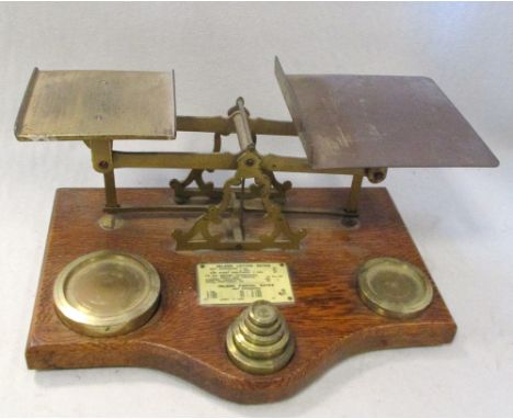 A set of 19th century oak and brass mounted postal scales, with ivorine letter rates plaque, 33cm (13in) wide  