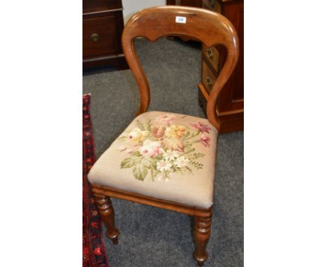 A Victorian mahogany balloon back chair, stuffed-over tapestry seat, turned legs, c.1860