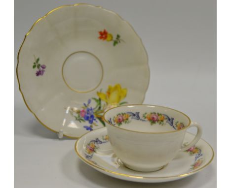 A Meissen saucer, decorated with flowers and sprigs, gilt line rim, crossed swords;  a Fürstenberg cabinet cup and saucer, de