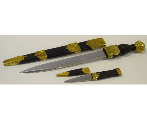 A Scottish Piper's Dirk 28cm blade, rope carved and studded ebony grip, the scabbard with gilt metal mounts embossed with thi