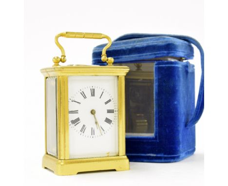 Miniature carriage clock timepiece within a corniche gilded brass case, 4" high; also with blue velvet travelling case