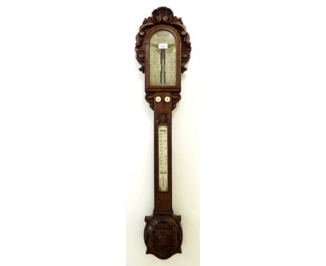 Large carved oak stick barometer/thermometer, signed Hills, Sudbury above the angled scales, over a square reeded section tru