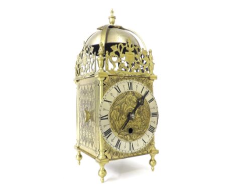 Brass fusee lantern clock, the 5.5" silvered chapter ring enclosing a foliate engraved centre, surmounted by pierced foliate 