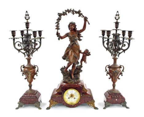 French red marble and bronzed spelter two train figural mantel clock garniture, the 3.5" cream dial inset into a stepped base