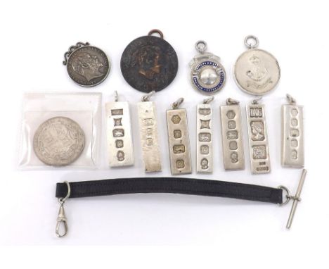 Seven assorted silver ingot pendants, 146gm approx; King's Shropshire Light Infantry 1938 football medallion, another silver 