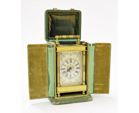 Contemporary carriage clock timepiece within an ornate brass case, 4.5" high (key); also with folding green tooled leather tr