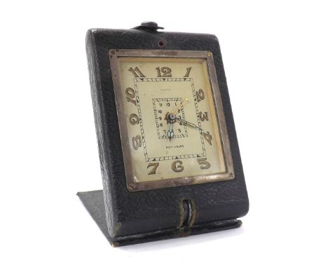 Vintage Cartier eight days alarm travel clock in a green leather folding case, the rectangular dial with Arabic numerals and 