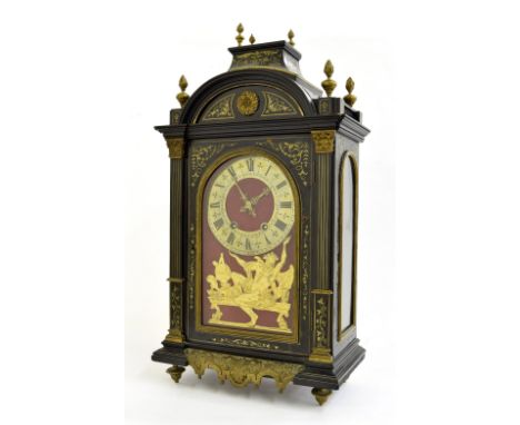 French ebonised and brass inlaid two train mantel clock striking on a gong, the 6.25" brass dial over a figural gilt metal em