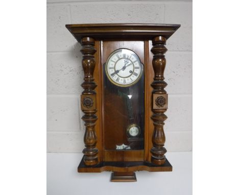An early 20th century mahogany cased eight day wall clock with enamelled dial