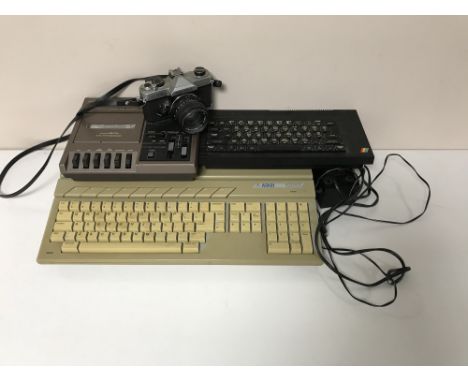 A box containing an Atari 520ST together with data recorder deck, Sinclair ZX Spectrum Plus and a Fujica ST705 camera
