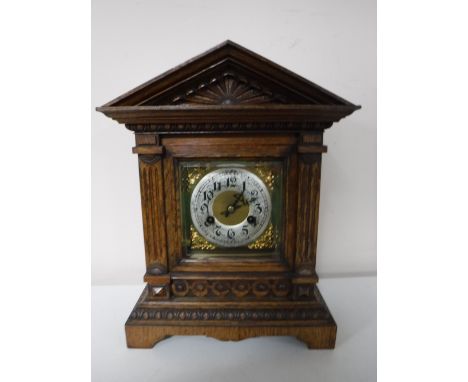An early twentieth century carved oak cased bracket clock