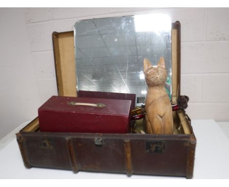 An early 20th century wooden bound trunk containing a dressing table mirror, cased sewing machine, walking sticks, large wood