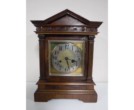 An early 20th century mahogany bracket clock with brass and silvered dial. 