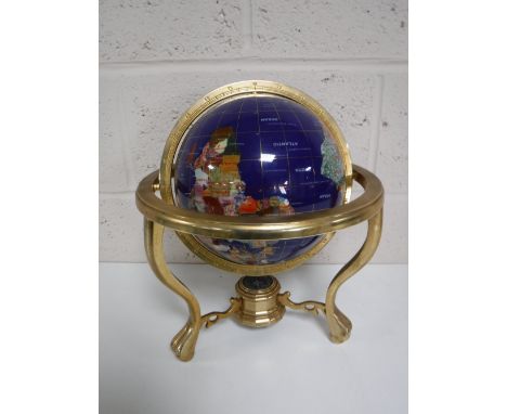 A gemstone table globe on brass stand