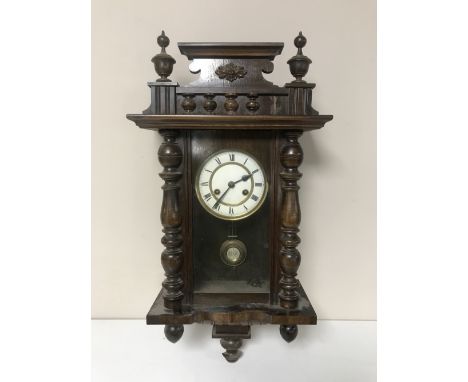 An oak cased eight day wall clock