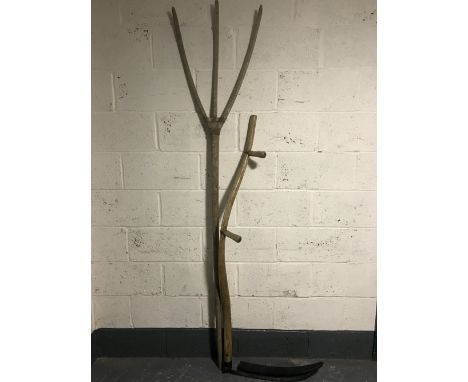 An early 20th century rustic hay fork together with a scythe