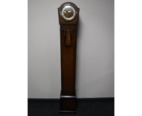 An oak cased granddaughter clock
