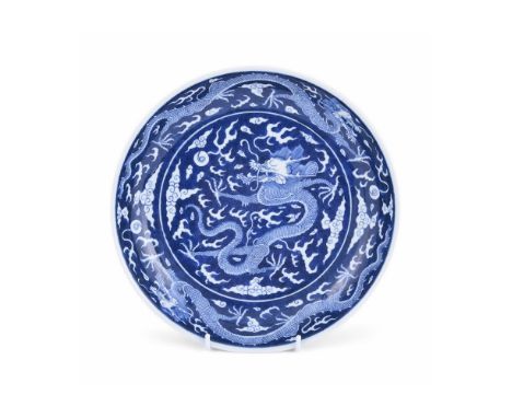 A Chinese blue and white 'Dragon' plate, mark of Daoguang and possibly of the period, painted to the interior with a writhing