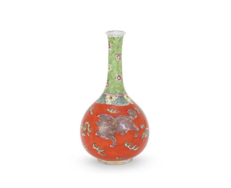 A Chinese Famille Rose 'clobbered' bottle vase, Kangxi, painted with Buddhist lions amongst clouds, iron read seal mark to ba