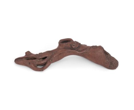 A Chinese Yixing 'Prunus trunk' brush rest, Qing Dynasty, moulded as a a gnarled prunus branch issuing prunus blossom, the ba
