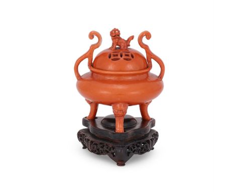 A Chinese Dehua iron-red glazed tripod censer, Daoguang, the pierced domed cover with Buddhist lion finial, the censer standi