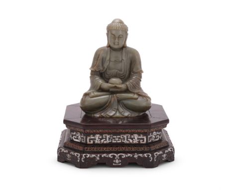 Y&nbspA pale celadon jade carving of a seated buddha, seated in dhyanasana with hands holding a bowl, dressed in long flowing