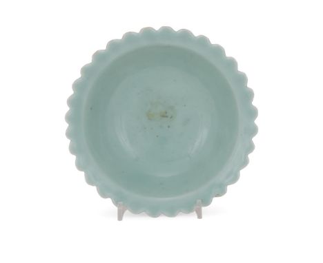 A rare Chinese celadon 'Chrysanthemum' bowl, Qianlong seal mark and period, of conical shape on a high straight foot and ever