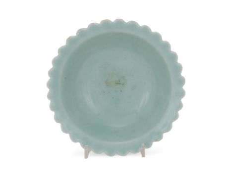 A rare Chinese celadon 'Chrysanthemum' bowl, Qianlong seal mark and period, of conical shape on a high straight foot and ever