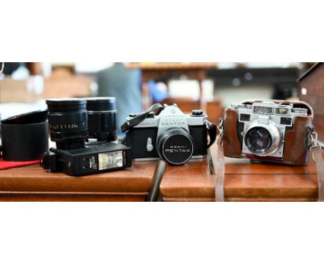 An Asatic Pentax Spotmatic F slr camera with SML Takumar 1:1.8/55 lens, Soligor Tele-auto 1:2.8 f=135mm lens and Soligar Wide