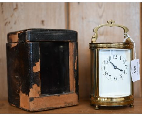 An unusual cylindrical carriage clock with bevelled glass panels (enamel dial a/f), 16 cm overall, in leather case (also a/f)