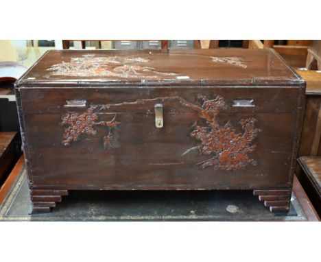 A Chinese camphorwood trunk carved with birds, bamboo and prunus, 94 x 44 x 50 cm high 