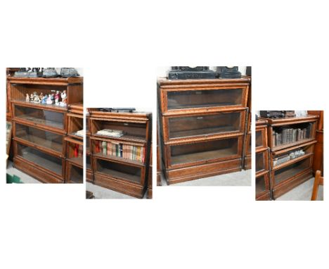 Four oak Globe Wernicke library bookcases, the largest with four graduated glazed in sections, on a deep plinth base, 87 cm w