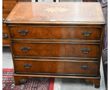 A reproduction cross-banded yew chest of three&nbsp; drawers with inlaid top, on shaped bracket feet, 79 cm x 43 cm x 67 cm h