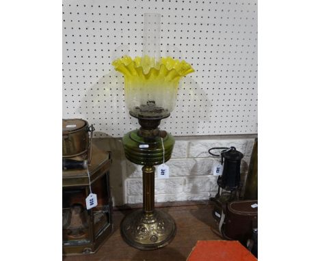 A Circular Based Brass Column Oil Lamp With Green Reservoir &amp; Yellow Tinted Etched Shade