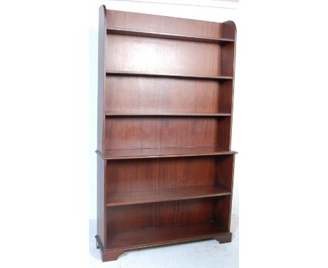 An antique style mahogany open window bookcase. The block case comprising of two parts with fixed shelves raised on bracket f