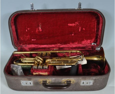 A vintage retro circa 1950’s trumpet by Melody Maker England. The large brass trumpet having mother of pearl sound keys and m