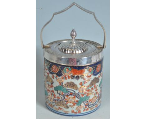 A vintage style 20th century imari pattern biscuit barrel with polychrome and gilt glaze to the body and a white metal lid wi