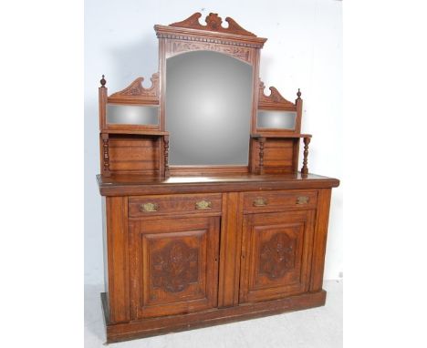 A 19th century Victorian oak mirror back sideboard chiffonier. Raised on a plinth base with carved foliate fielded panel door