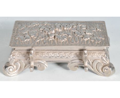 A 20th century Chinese oriental white metal desk inkwell. The inkwell having a hinged lid opening to reveal three white ceram