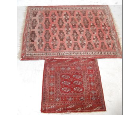 A vintage 20th century Persian / Iranian / Islamic carpet having a red background with black and white geometric patterns and