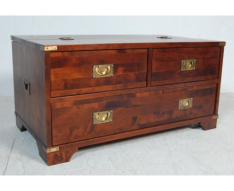 A contemporary Laura Ashley campaign chest / coffee table. The chest having two shower drawers over a long drawer to one side