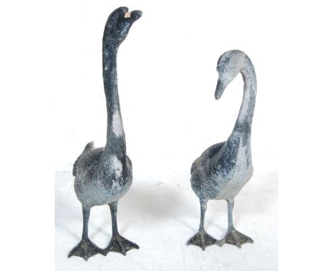 A good pair of 20th century garden statue - geese, Each of varying pose constructed of bronze / metal. measuring 71cm largest