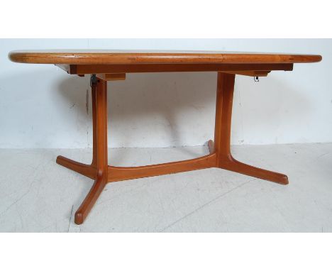 A vintage retro 20th century circa 1970s teak wood extending dining table by Dyrlund. The table having a rectangular two piec