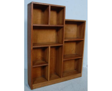A vintage retro mid 20th century circa 1950’s oak opened window bookcase. The bookcase of a step form having pigeonhole setup