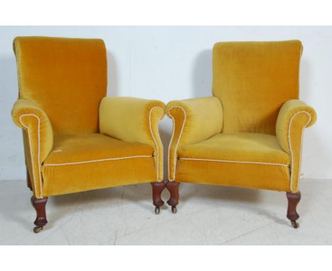 A pair of vintage retro mid 20th century yellow velvet armchairs / easy chairs. The chairs having a high back rest with barre
