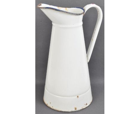 A vintage 20th Century French enamelled jug of cylindrical tapering form, being white enamelled throughout with a further blu